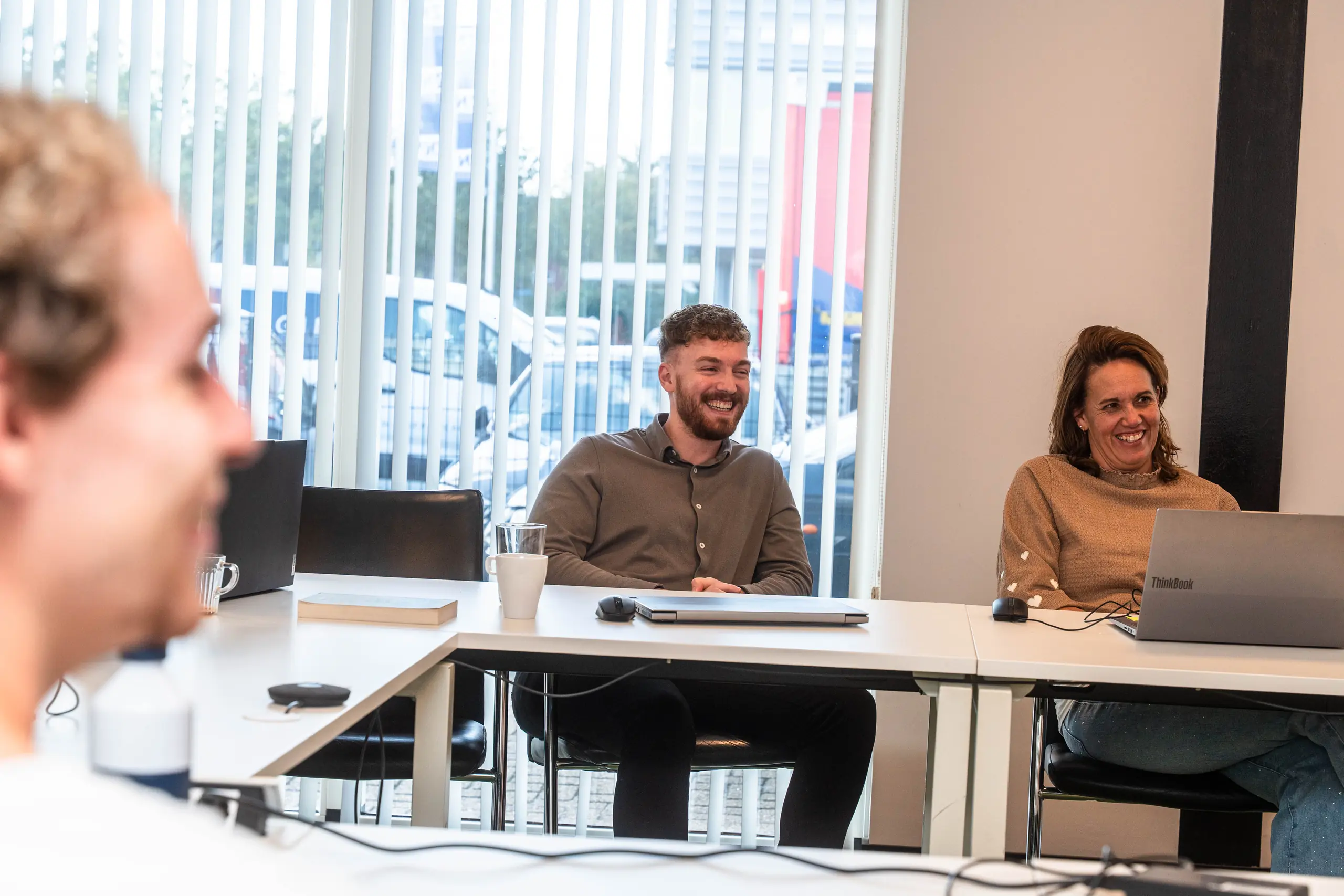 Collega’s lachen tijdens een overleg bij De Vaart